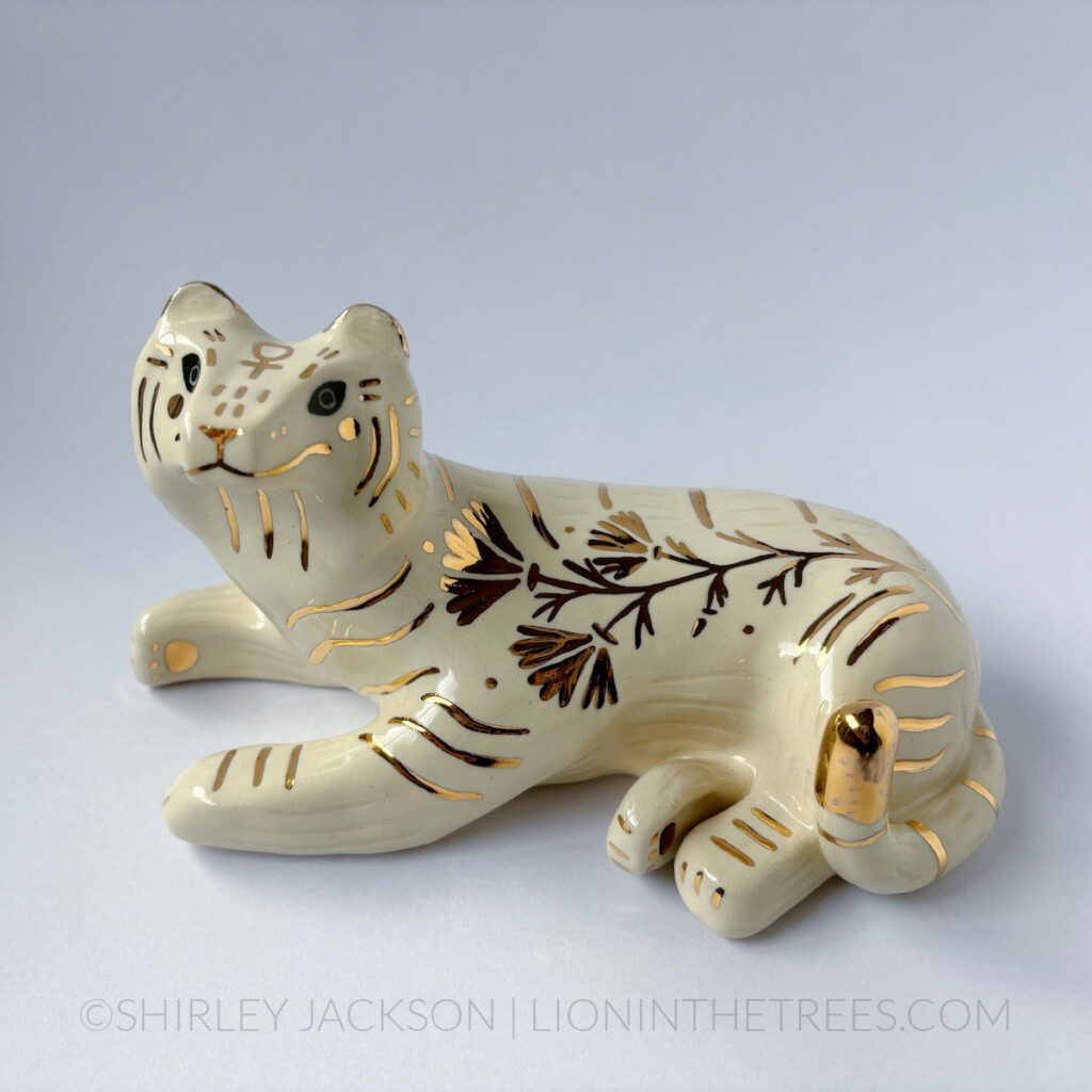 Sgraffito white/gold tiger totem with California Poppy motifs on it's side, and the sign of Venus on it's forehead.