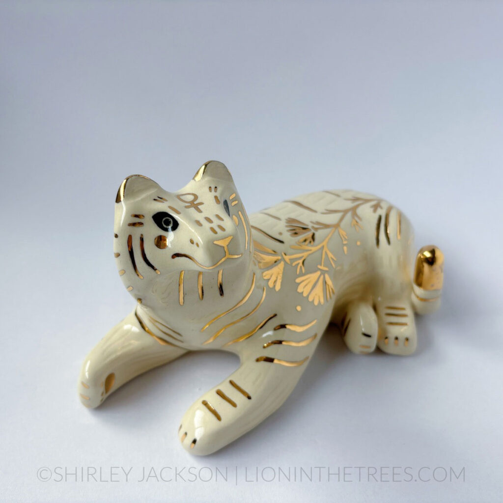 Sgraffito white/gold tiger totem with California Poppy motifs on it's side, and the sign of Venus on it's forehead.