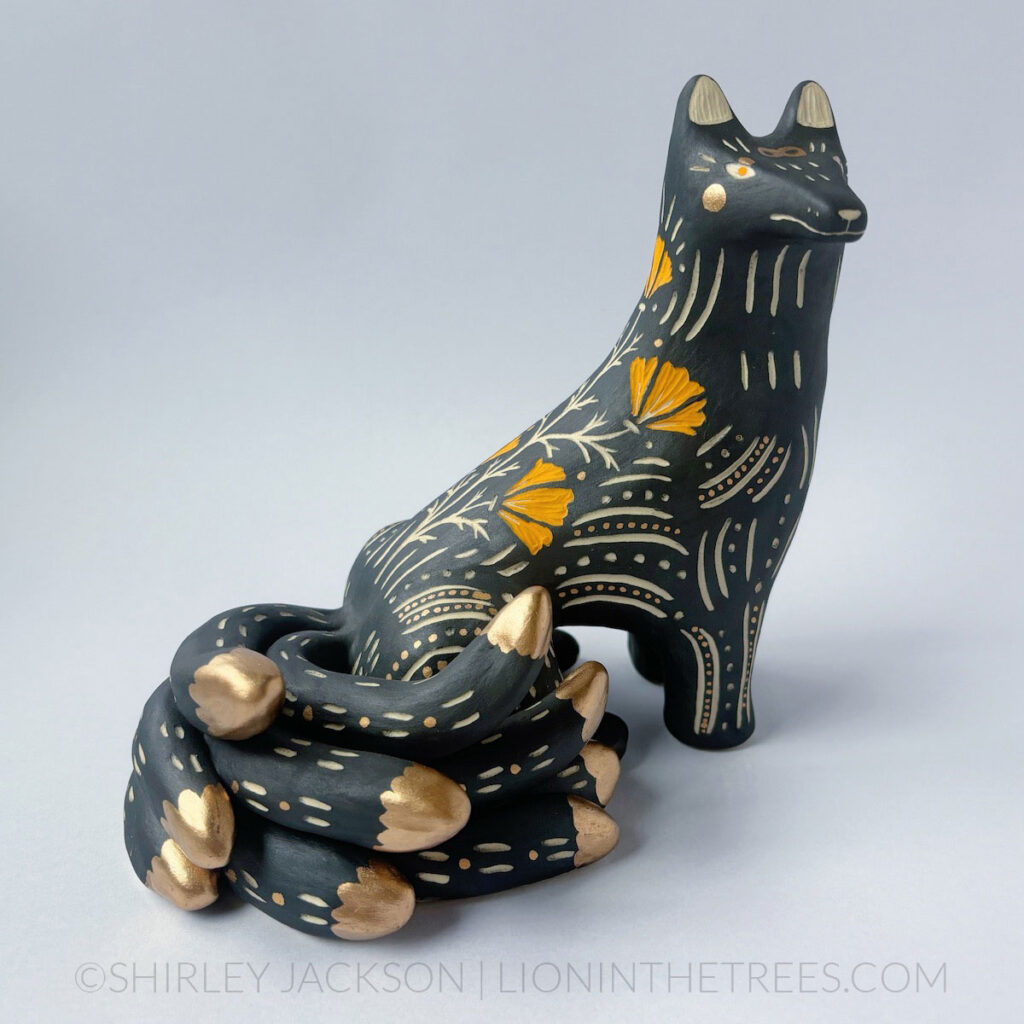 Black and orange sgraffito kumiho with gold luster details.