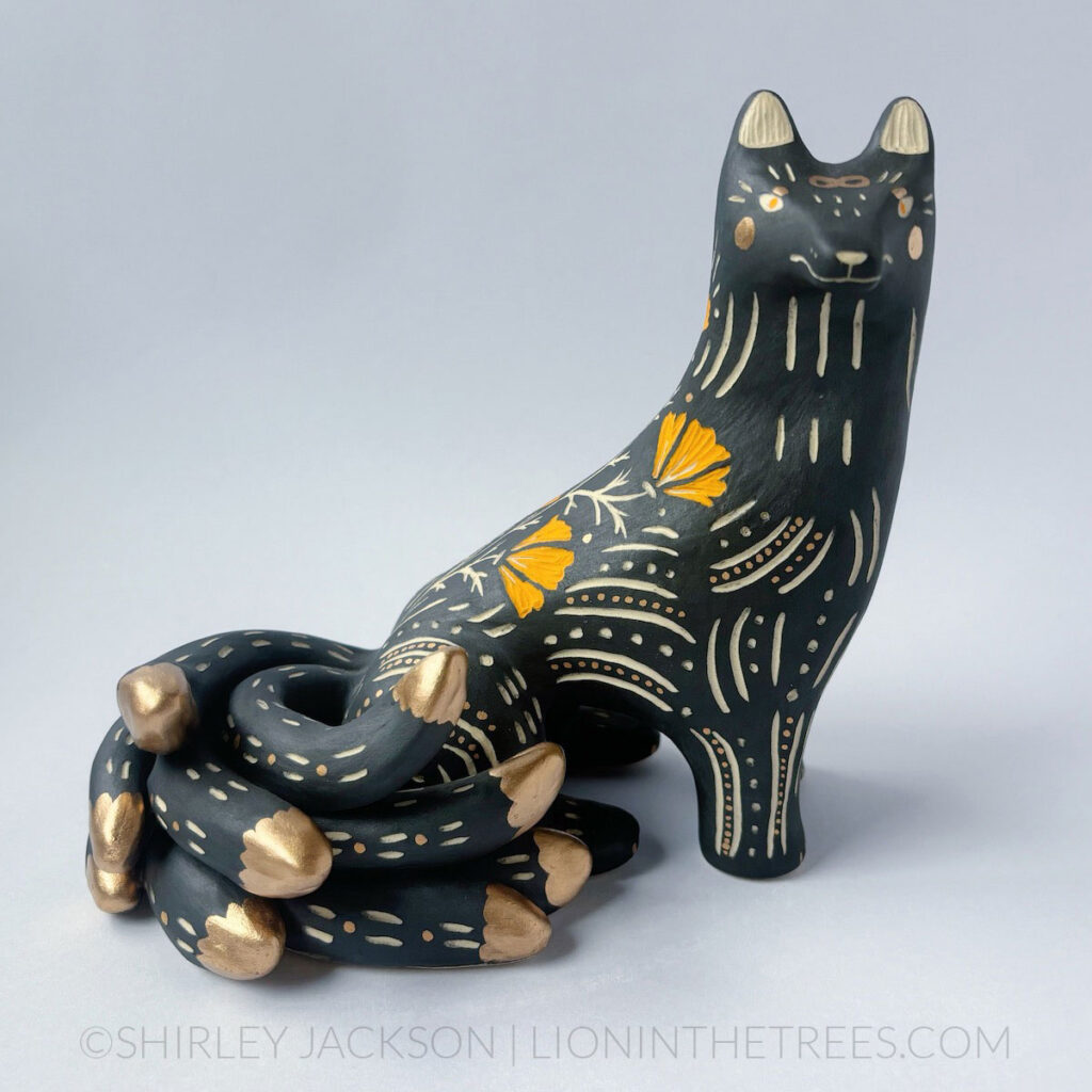 Black and orange sgraffito kumiho with gold luster details.