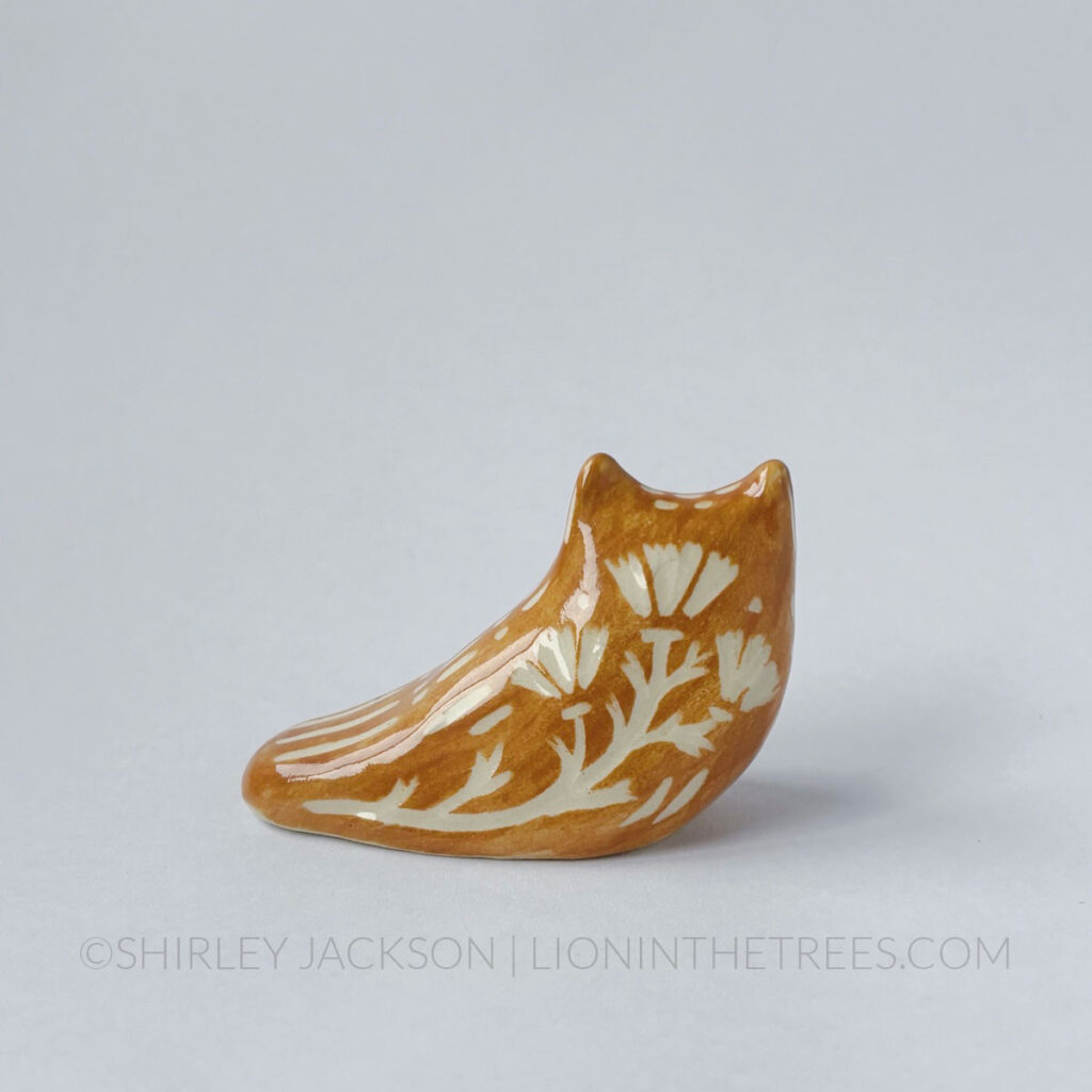 Brown underglaze sgraffito Great Horned Owl totem. Back view showing the California Poppy motif carved into it's back.