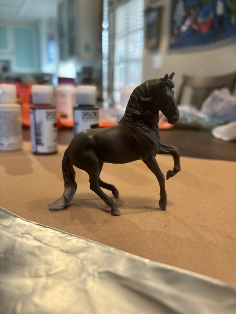 The horse with the first layer of a dark grey painted on