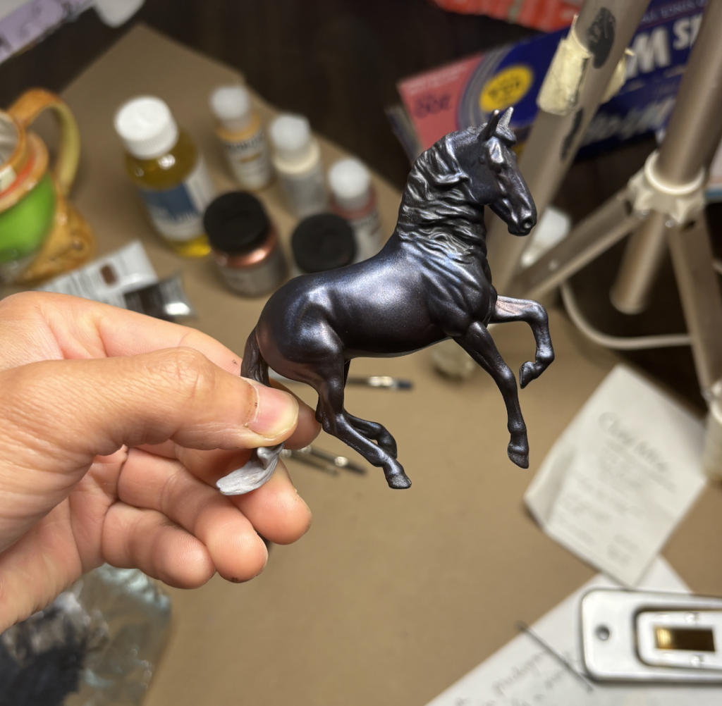 The horse after having interference blue and copper tones added. It gives the black coat a purple shimmer.