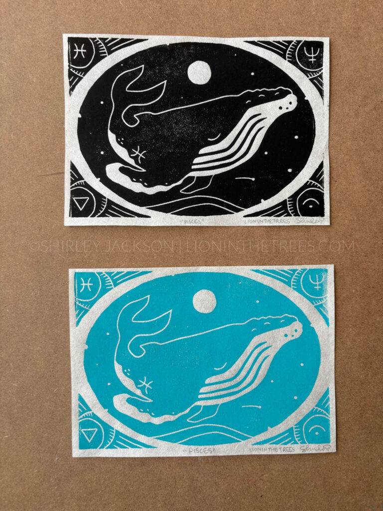 Photo showing two block prints of my humpback whale Pisces design. The top print was done with black ink and the print on the bottom was done with a turquoise ink.