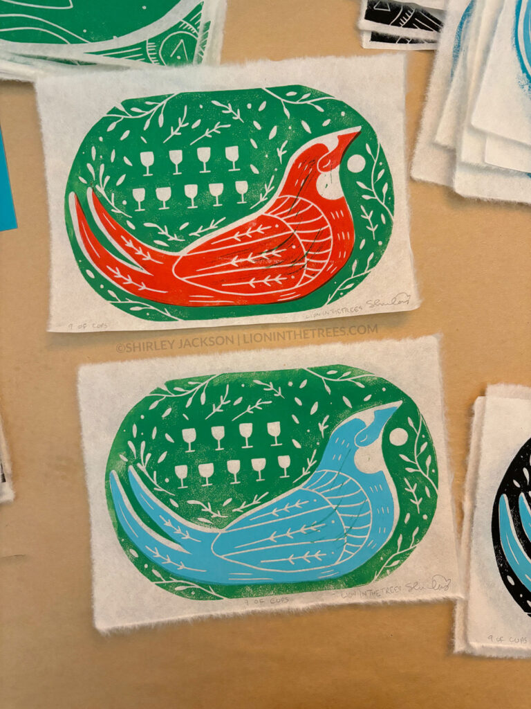 Collection of swallow prints featuring a green background and red or blue printed birds.