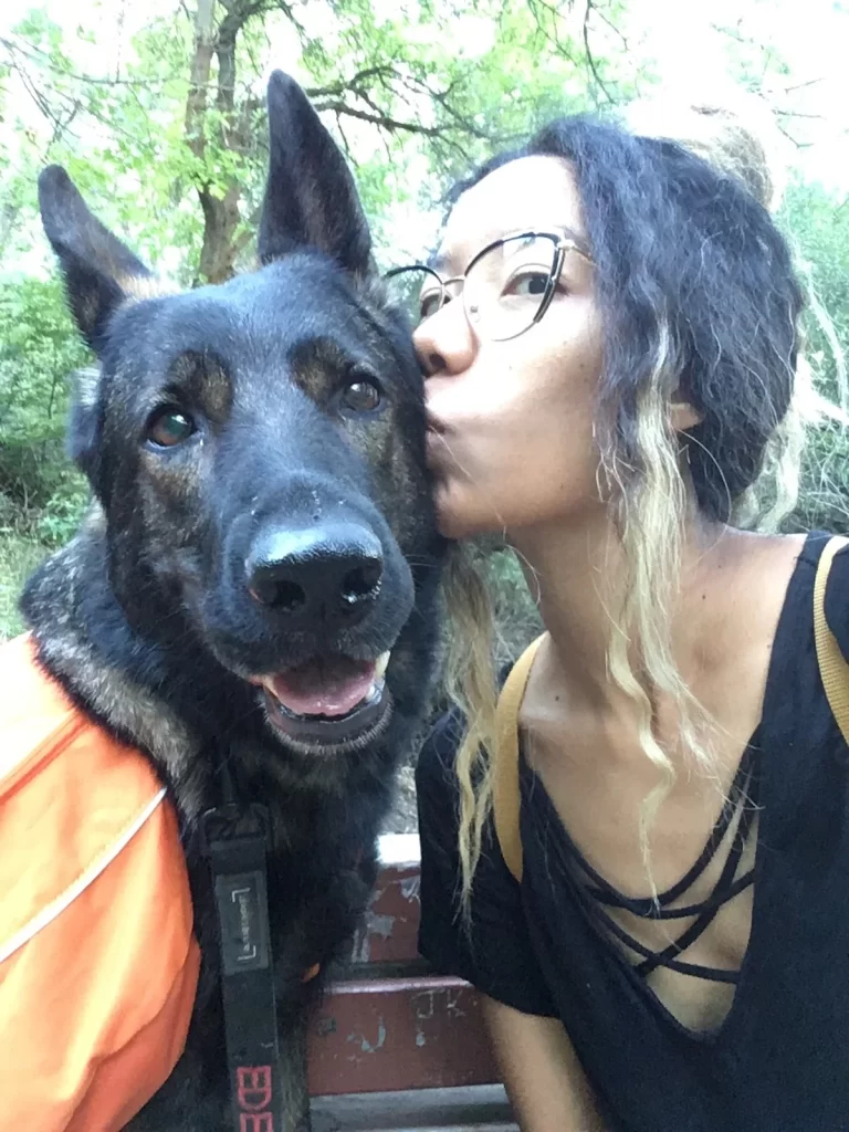 Me and Eden sitting on a park bench and I'm giving her a smooch on the cheek while she's looking at the camera