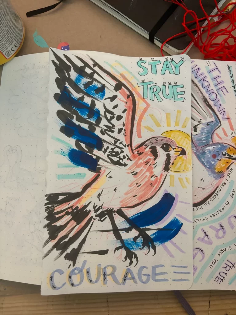 Marker and ink sketch of a kestrel with the words "Stay true" and "courage" on the page.