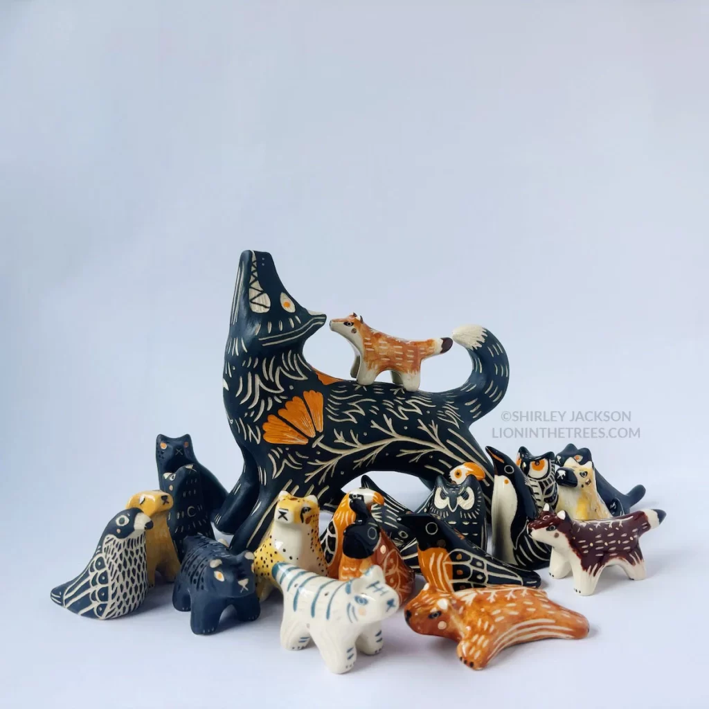 Group photo of this latest batch. It looks as though the large, howling wolf sculpture is baby-sitting a bunch of smaller animals and they're just crowding around them.