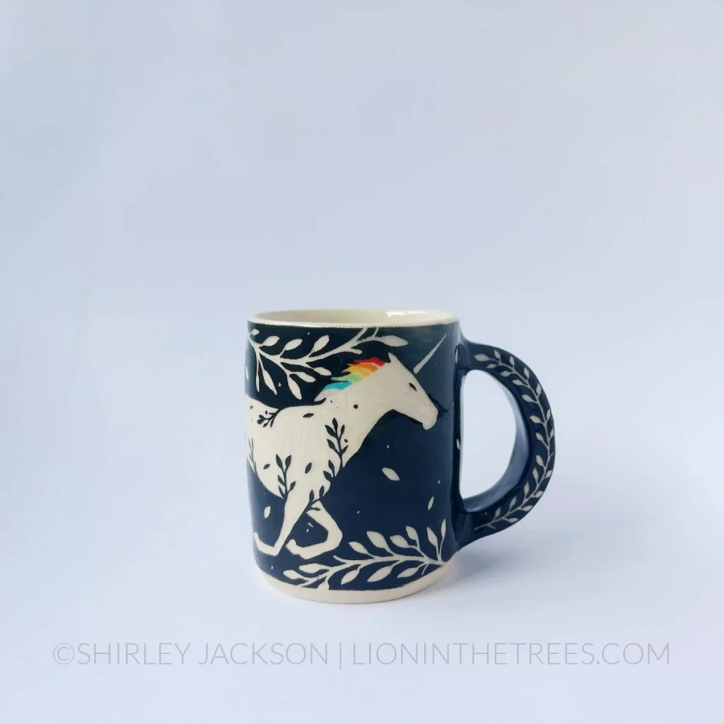 Black and cream sgraffito mug featuring my Rainbow Unicorn motif and floral elements