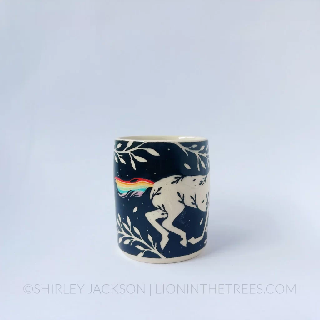 Black and cream sgraffito mug featuring my Rainbow Unicorn motif and floral elements