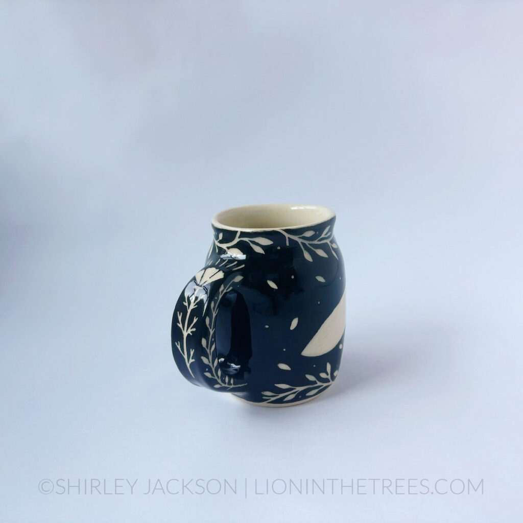 Black and cream sgraffito mug featuring my Running Fox motif and floral elements
