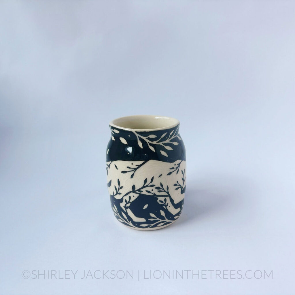 Black and cream sgraffito mug featuring my Running Fox motif and floral elements