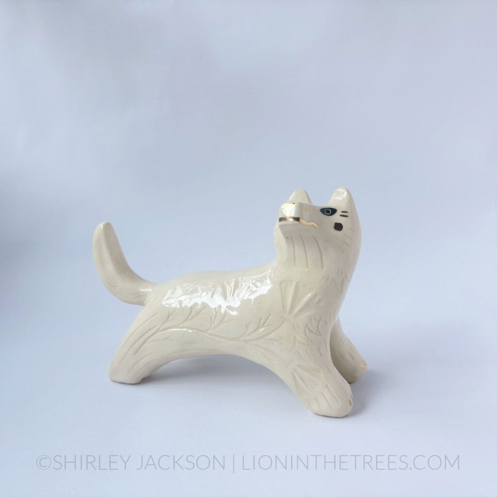 White Wolf totem done in a pose that looks as though the wolf is leaping.