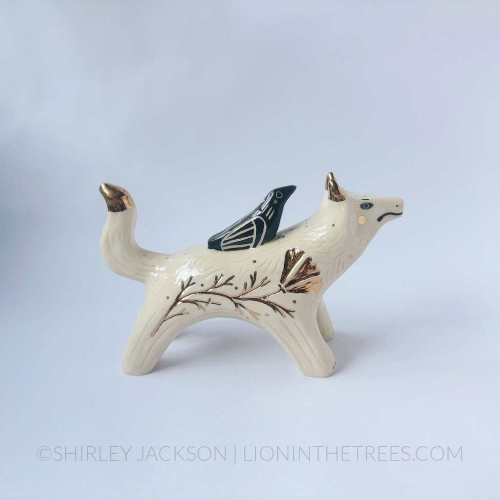Wolf and Raven Friend totem done with black underglaze, clear glaze, and gold luster.