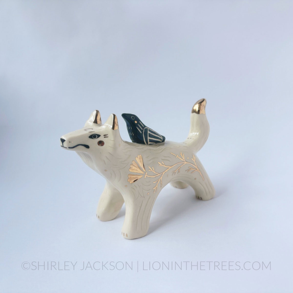 Wolf and Raven Friend totem done with black underglaze, clear glaze, and gold luster.