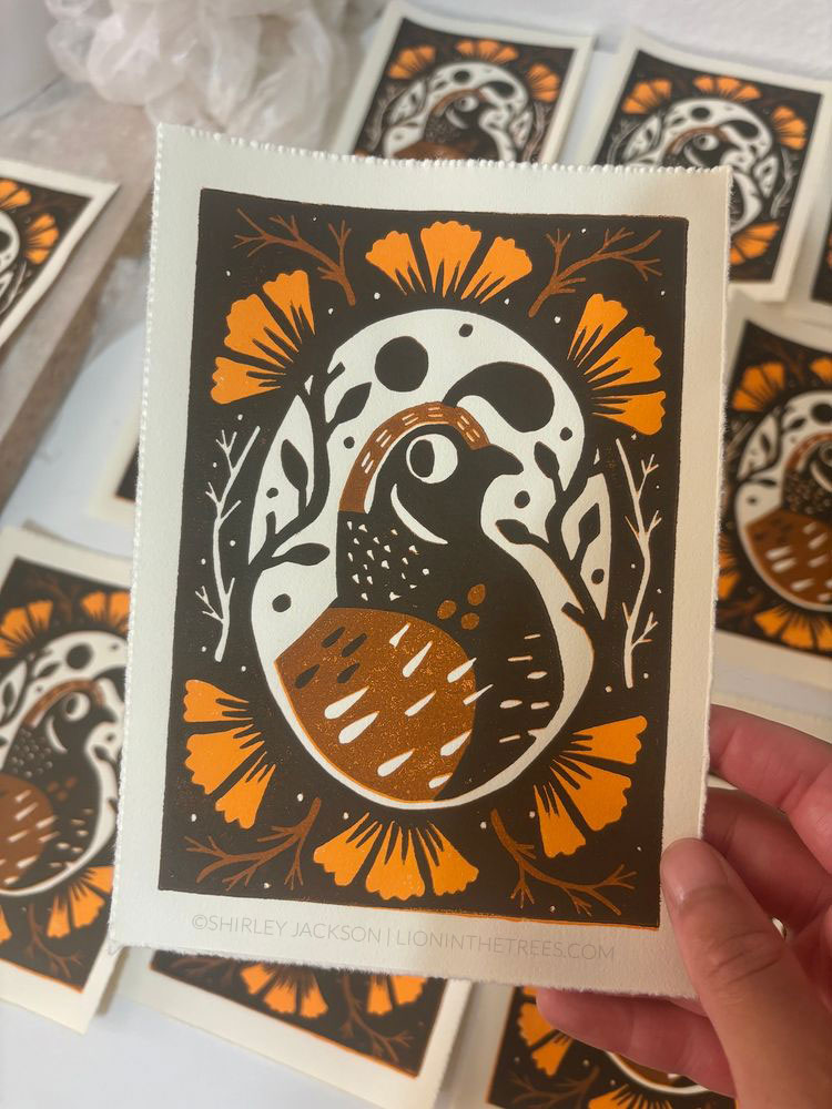 Linoblock relief print of a California Quail done with browns and orange.