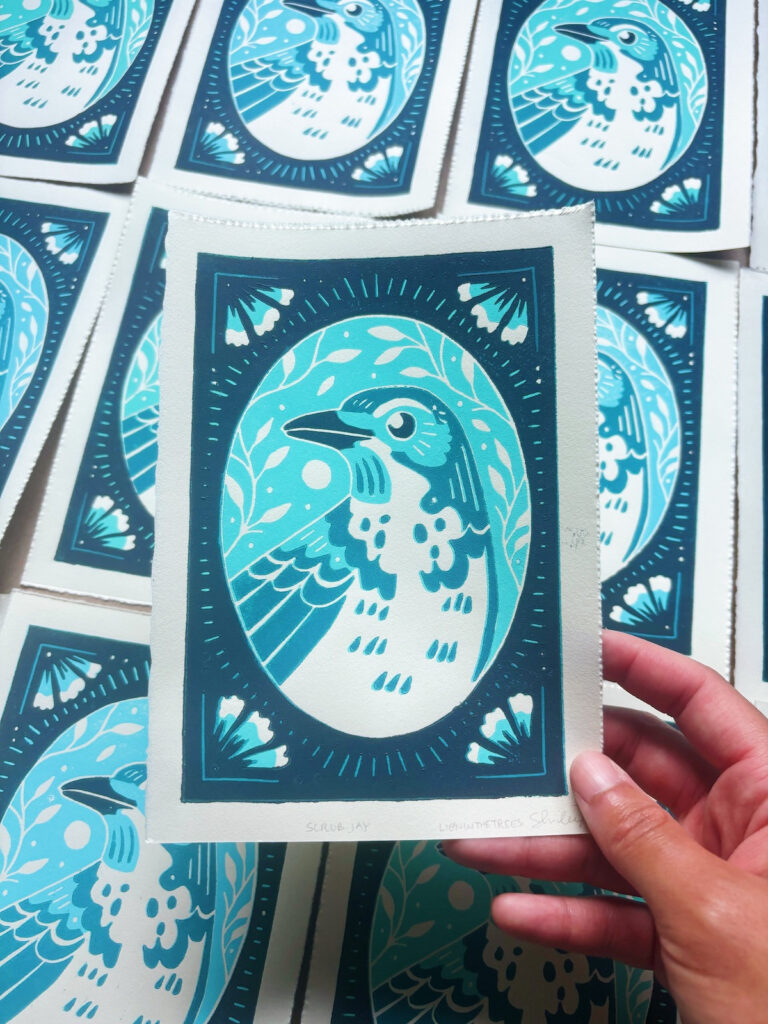 Linoblock relief print of a California Scrub Jay done with a lighter green-ish turquoise and blue ink.