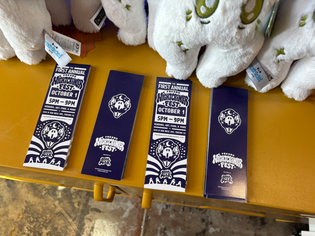 A close up shot of bookmarks that resemble the Fresno Nightcrawler Fest banner design.